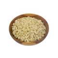 Wooden bowl filled with macadamia pieces on a white background