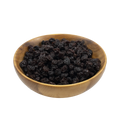 Wooden bowl filled with raisins on a white background