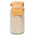 Jar of premium pea protein powder with a label on a white background