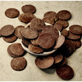 Solomon's Gold Dark Chocolate Buttons 70% spilling out of a small bowl on a beige background