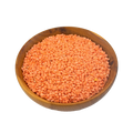 Wooden bowl filled with split red lentils on a white background