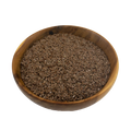 Wooden bowl filled with flaxseeds on a white background