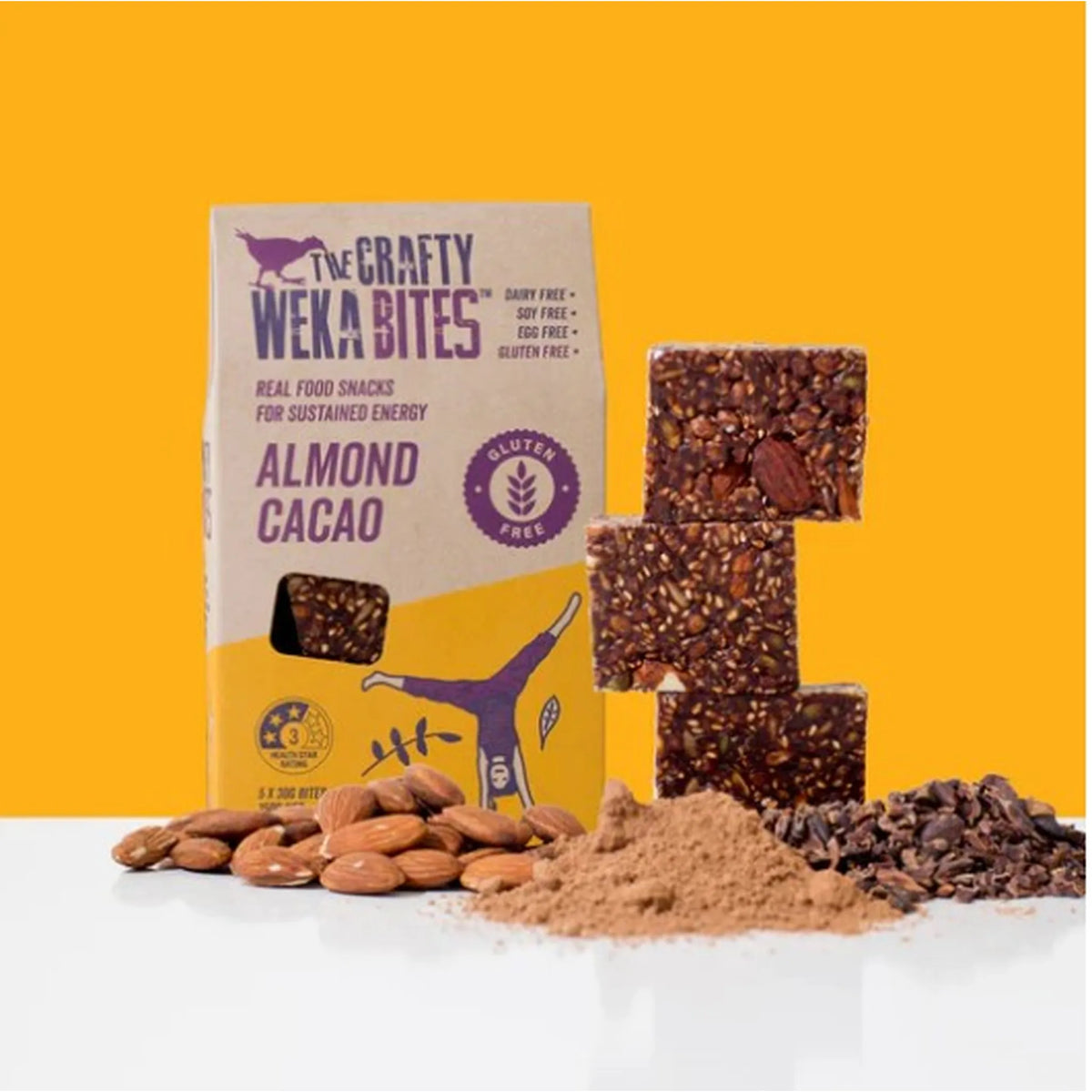 The Crafty Weka Bites almond cacao snack package with ingredients on a yellow background