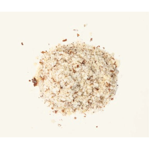 a small pile of natural almond meal on a white background