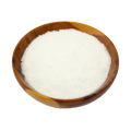 Wooden bowl filled with white sugar on a white background