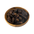 Wooden bowl filled with dark brown dates on a white background