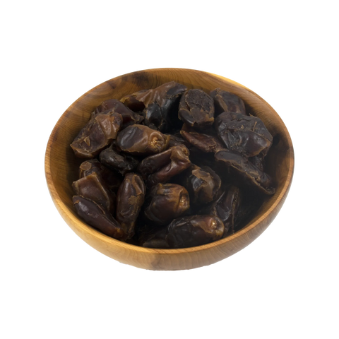 Wooden bowl filled with dark brown dates on a white background