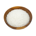 a wooden bowl with desiccated coconut on a white background