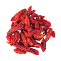 Pile of red goji berries on a white background