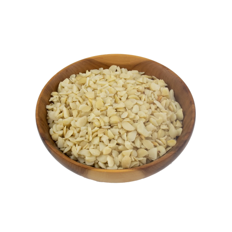 Wooden bowl filled with macadamia pieces on a white background
