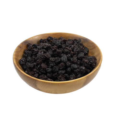 Wooden bowl filled with raisins on a white background