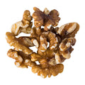 A small pile of whole walnuts on a white background
