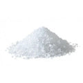 Pile of white coarse sea salt on a white background