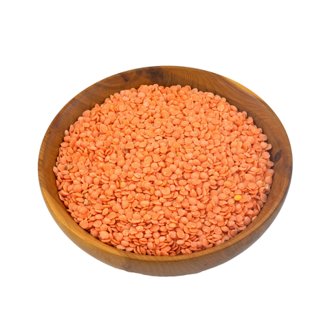 Wooden bowl filled with split red lentils on a white background