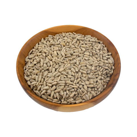 Wooden bowl filled with sunflower seeds on a white background